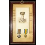 Framed BWM & Victory Medal plus large photo and officers cap badge. Medals named Lieut C D