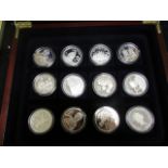 World Silver Proofs (12) All Crown size and housed in a plush box. aFDC - FDC