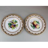 Two Minton plates. The centres depicting fruit with the outer edge in gold, approx size 23.5cm