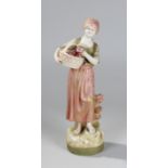 A Royal Dux figure of a lady holding a basket with flowers, 27cm high, pink triangle mark to base