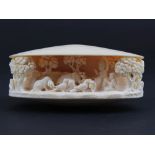 Oyster Shell carved Ivory Pastoral Scene with seated Deity, birds and animals, in its fitted case
