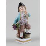 Volkstedt porcelain figure of a young man holding grapes , approx 11.5cm high