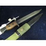 Bayonet: No 5 MK1 bayonet in its metal scabbard with web frog. Wood grips. In very good condition.