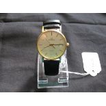Gents circa late 1980s Garrard 9ct gold wristwatch (engraved on the back) on a leather strap,