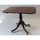 Early 19th century rectangular tilt top side table on a single leg with a tripod base. On castors