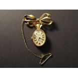 A 9ct hallmarked ladies Rotary fob watch with an oval dial suspended from brooch modelled as a