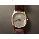 Gents Omega 9ct gold cased wristwatch with an black oval dial on a brown leather strap