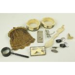 Mixed lot including a gilt sovereign purse, two bone napkin rings and a spoon, a miniature cast iron