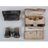 Two pairs of early 20th century opera glasses both in fitted cases