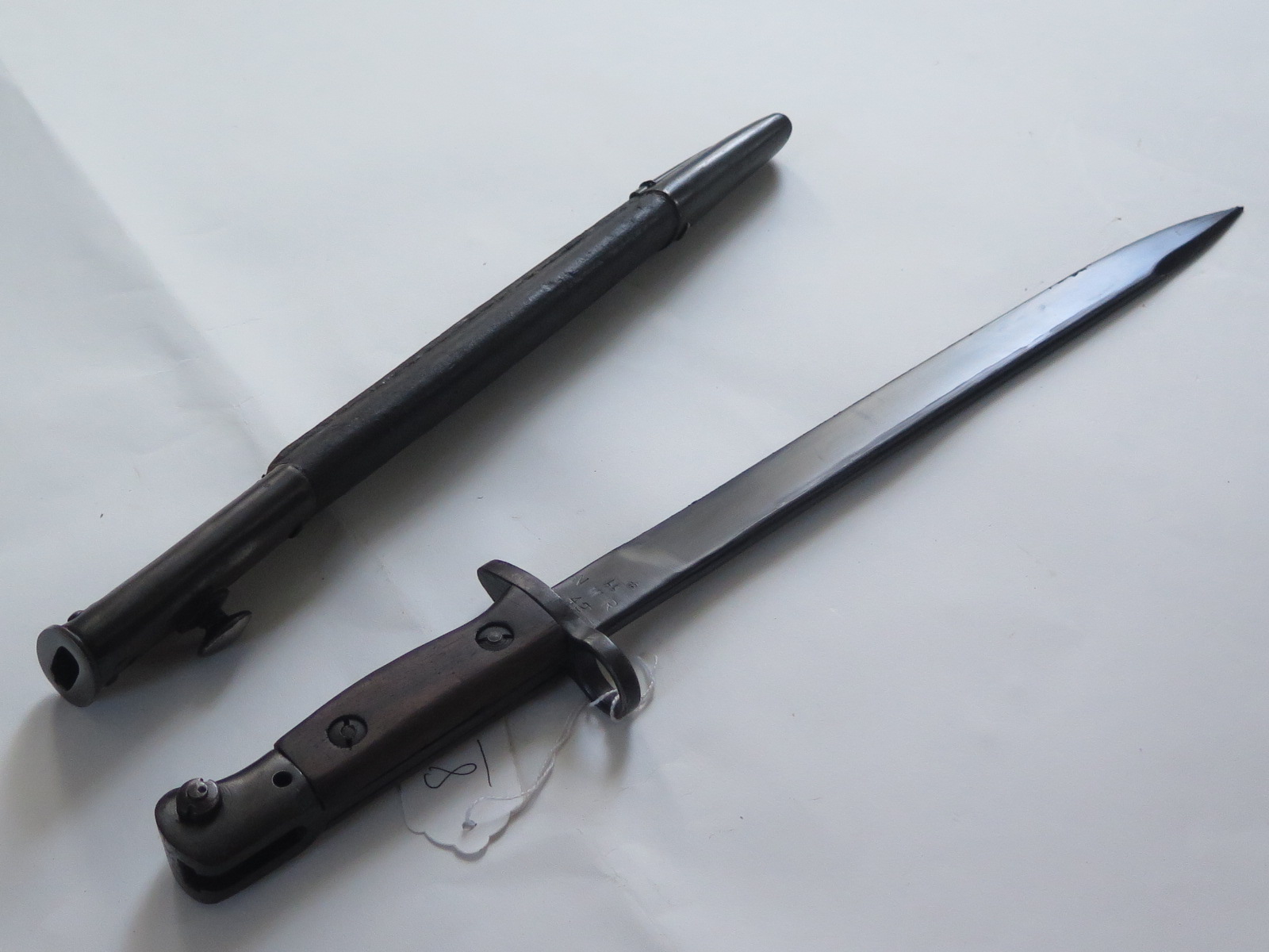 Bayonet: A good India Pattern MKII short SMLE bayonet. Unfullered blade 12". Ricasso marked N.W.