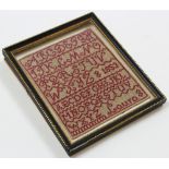 Miniature alphabetical sampler in wool on cloth, named Laura 1853 in a period ebony and gilt frame