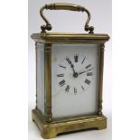 Brass framed five glass carriage clock with black Roman numerals on a white face Approx height