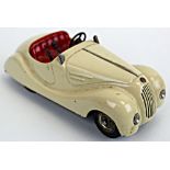 Schuco Examico 4001 tinplate clockwork car, cream with red seats