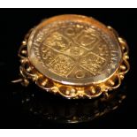 George I Shilling dated 1723 gilded and housed in a yellow metal brooch mount