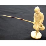 Japanese figure of a man fishing carved in ivory with the rod being a quill