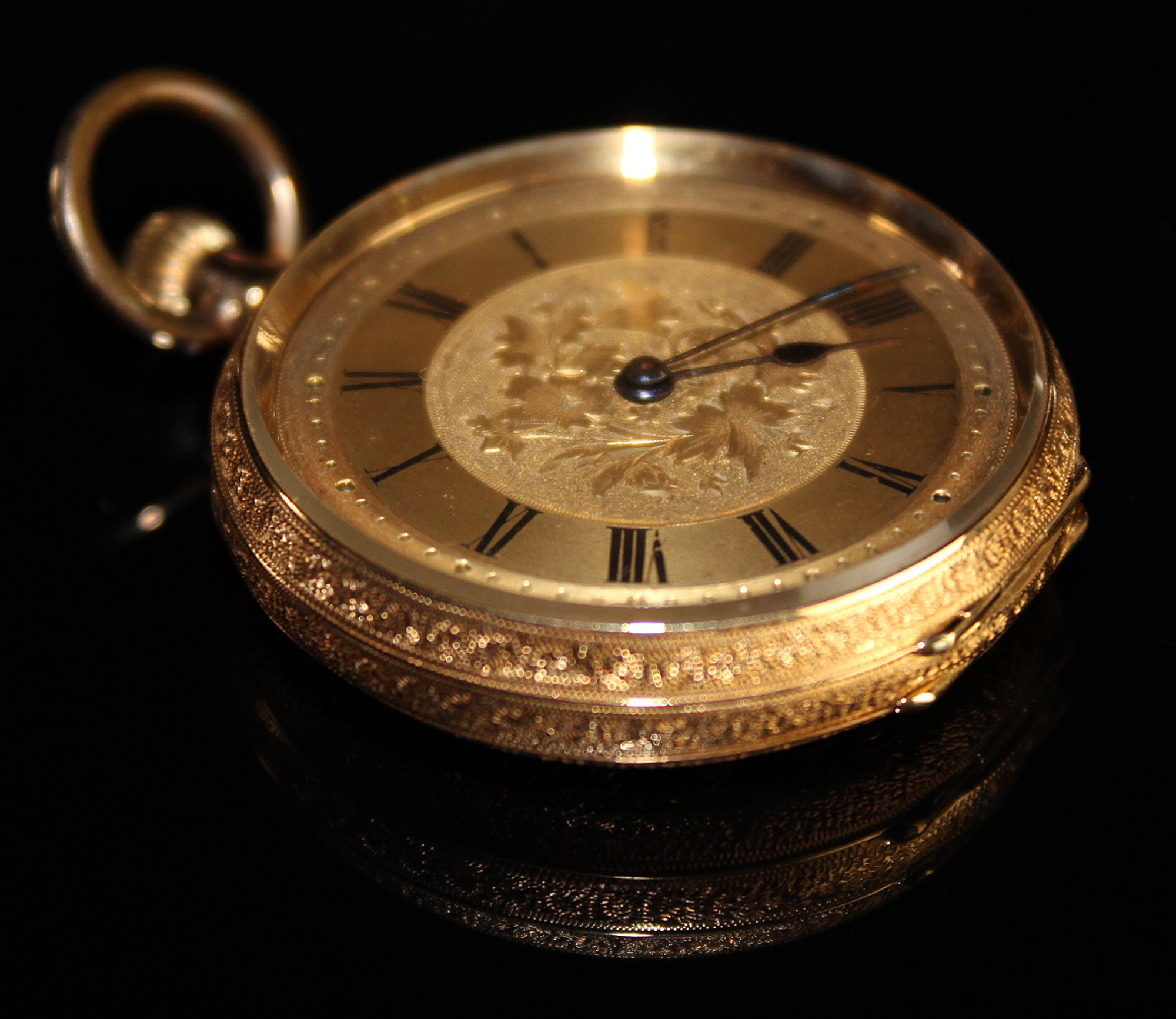 Ladies 18ct gold pocket watch the gilt dial with black roman numerals, foilate design in centre