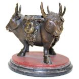 19th century bronze deskstand in the form of three bulls heads mounted on three cloven hooves