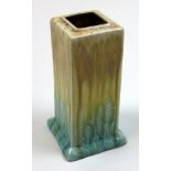 An early 20th century Ruskin vase of square form, decorated with drip glaze and with impressed