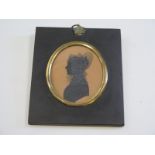 Very finely painted monochrome silhouette portrait of a lady circa 1817 mounted in an acorn topped