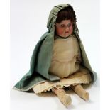 Edwardian bisque headed doll with a wooden body, dressed in period clothes