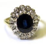 18ct Ring set with large central Sapphire surrounded by Diamonds size N weight 5.2 grams