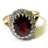 9ct Ring set with central Garnet surrounded by Diamonds size O weight 4.2 grams