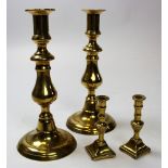 Two pairs of 19th century brass candlesticks one being 23 cm high and fitted with ejectors and the