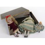 Three 19th century minature porcelain dolls dressed in knitted garments