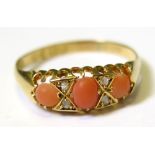 18ct Ring set with pink Coral stones size P weight 2.6 grams