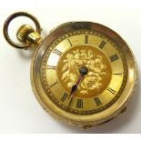 18ct gold ladies fob watch, black roman numerals on a gilt decorated dial. approx 30mm diameter