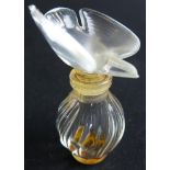 Lalique perfume bottle with a bird as a stopper. marked Nina Ricci lalique France to the base
