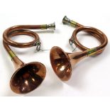 Pair of Victorian copper hunting horns with silvered brass mouth pieces and brass fittings. Each
