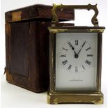 Brass framed five glass carriage clock with black Roman numerals on a white face "Castrell South