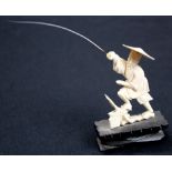 19th century carved Ivory Japanese fisherman. Mounted on an ebonised stand.