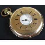 Half hunter 14ct gold pocket watch . The outer case with a black enamel dial opening to reveal the