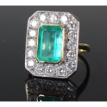18 carat gold diamond and emerald ring, with a central baguette emerald, surrounded with diamonds on