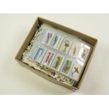 Box of loose cigarette cards and part sets in plastic pages (qty)