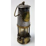 Miners lamp 'The protector lamp and lighting company by Eccles number 3557. Standing 24 cm high