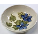 Moorcroft pin dish blue flowers on a cream ground. Stamped moorcroft to base 11cm across