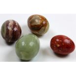 Four Chinese hardstone eggs including a jade example circa 1900, all with extensive graining and