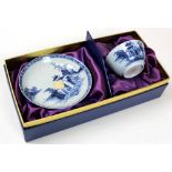 A pair of Nanking Cargo blue and white tea bowls and saucers decorated with tea pavillions on