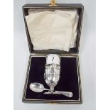 Silver matched three piece christening set, comprising egg cup, napkin ring and associated spoon,