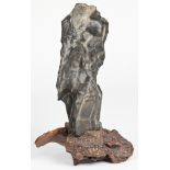 A Chinese Lingbi scholar's rock on burlwood stand. 19th / 20th century. Size: 21.5" x 13" x 8" (55 x