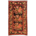 Caucasian Rug: 5' x 9' (152 x 274 cm), early 20th c.,  large floral sprays on a black field. CLICK