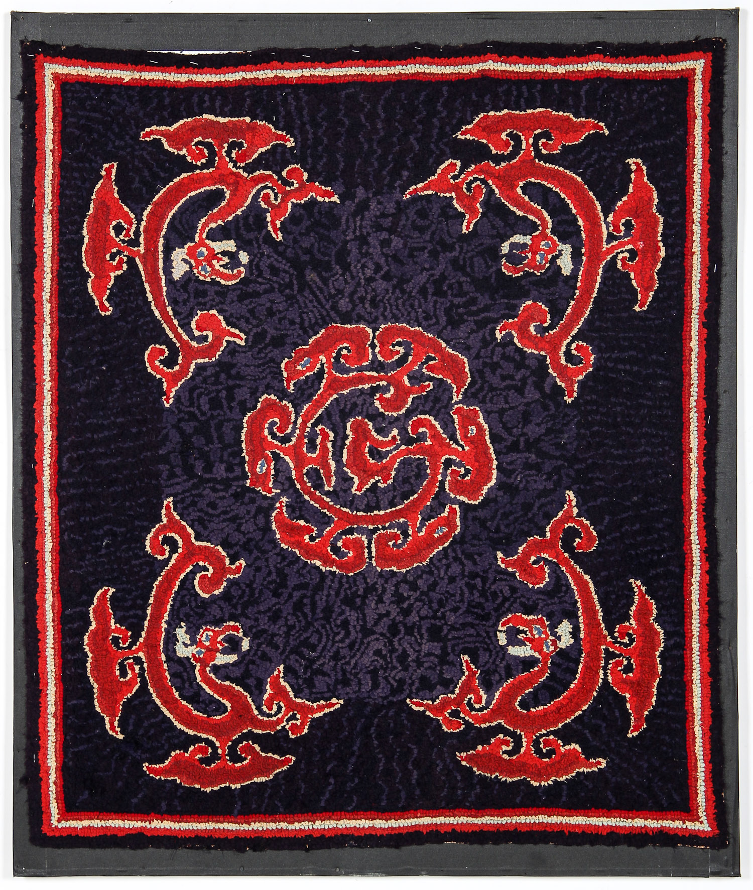 Antique American Hooked Rug in Asian Inspired Design: four red dragon-like forms circling a