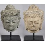 2 Vintage Southeast Asian Stone Buddha Heads, 20th c., one gray, other with pigment. Both on stands.