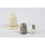 Ivory bell on an ivory base circled with gold. It contains 1 crystal bottle with a gold cork and 1