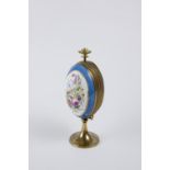 Porcelain egg on bronze base. Its structure is in golden metal and presents a mechanism that opens