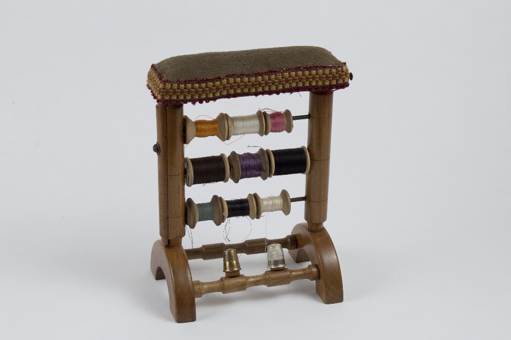 Boxwood sewing stand for 9 thread reels with 2 copper thimbles and 1 suspended scissors. It is
