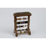 Boxwood sewing stand for 9 thread reels with 2 copper thimbles and 1 suspended scissors. It is